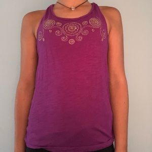 A purple heeled tank top with a know in the back